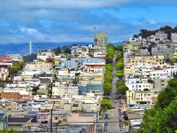 View of cityscape against cloudy sky
