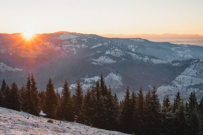 Scenic view of snowcapped mountains against sky during sunset