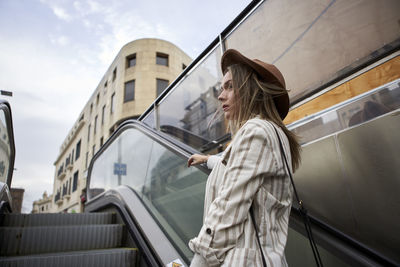 Side view of woman looking at city