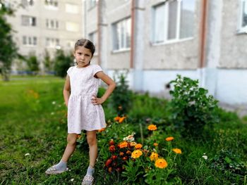 Portrait of girl standing against plants