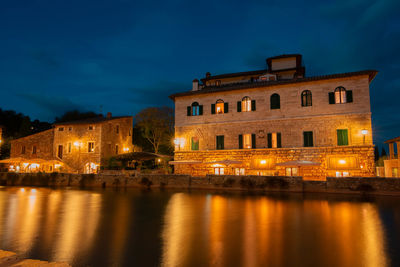 Reflection of illuminated buildings in water at night