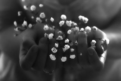 Close-up of cropped hand holding cigarette