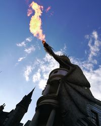 Low angle view of angel statue against sky