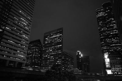 Low angle view of skyscrapers lit up at night