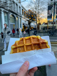 Cropped hand of person holding food