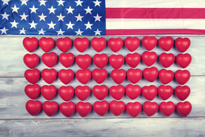High angle view of heart shapes with american flag on wooden table