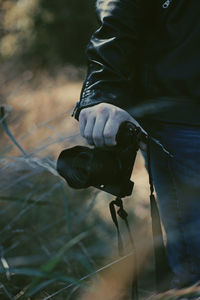 Midsection of person holding umbrella