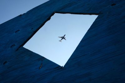 Low angle view of airplane flying in sky