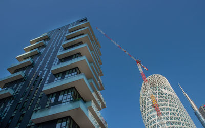 Low angle view of modern building against clear blue sky