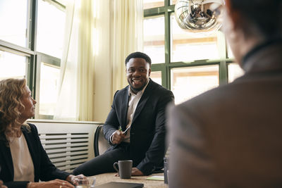 Side view of business colleagues working at table