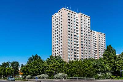 Low angle view of buildings against clear blue sky