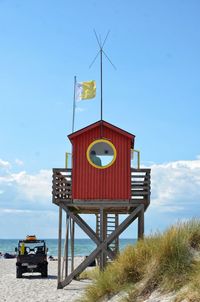 Lifeguard hut on beach against sky