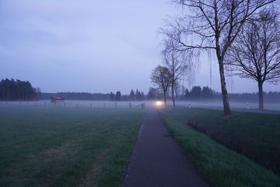 Scenic view of field against sky during foggy weather