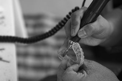 Cropped hands of person making braces