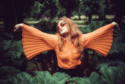 Close-up of young woman in leaves