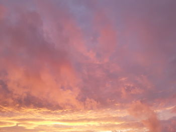 Low angle view of dramatic sky during sunset