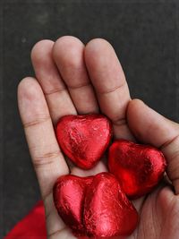 Close-up of hand holding strawberries