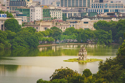 Reflection of trees and buildings in lake