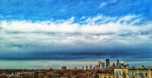 Buildings against cloudy sky