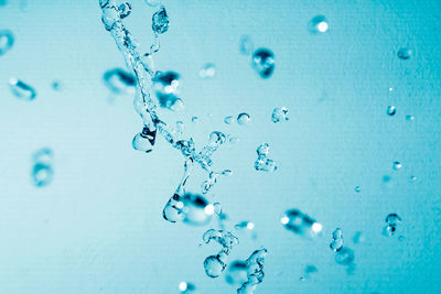 Water splashing against blue background
