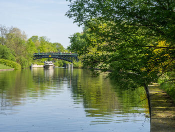 Arch bridge over river against sky