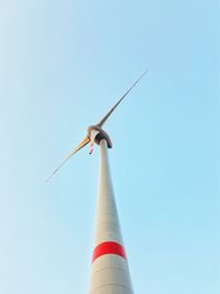 Low angle view of wind turbine against clear sky