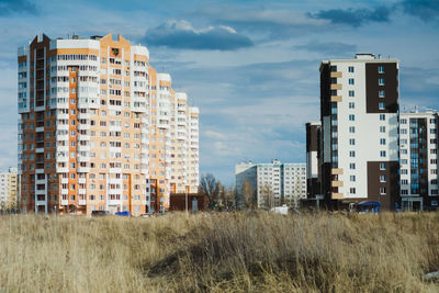 View of buildings against cloudy sky