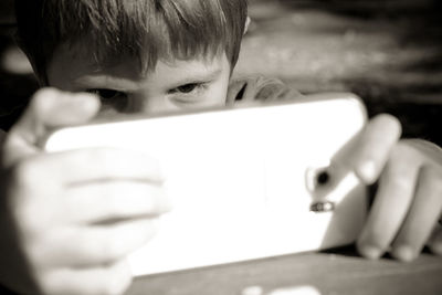 Close-up of boy holding mobile phone