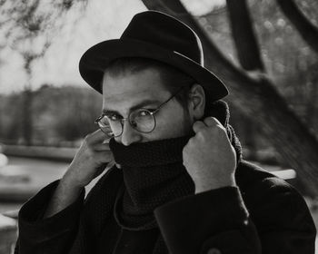 Portrait of young man using smart phone during winter