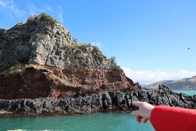 Rock formation in sea against sky