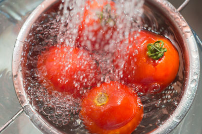 High angle view of tomatoes in strainer over sink