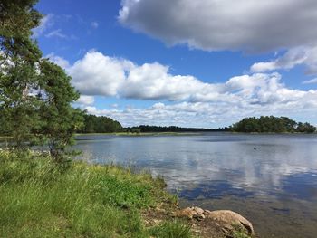 Scenic view of lake against cloudy sky