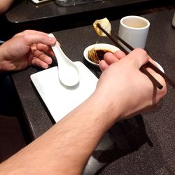 Close-up of cropped hand holding coffee