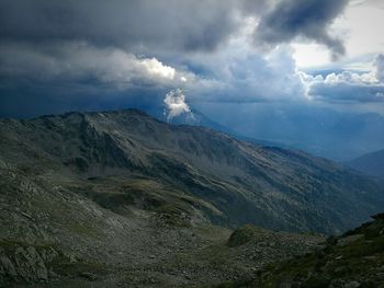 Scenic view of mountains against cloudy sky