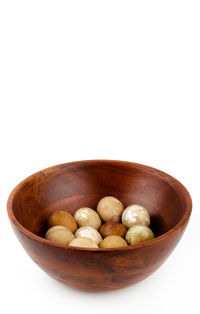 Close-up of fruits in bowl against white background