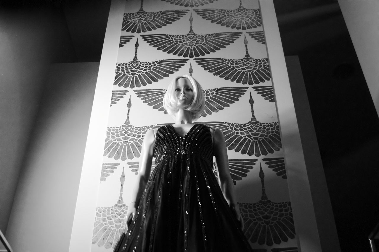 LOW ANGLE PORTRAIT OF YOUNG WOMAN STANDING ON CEILING AT HOME