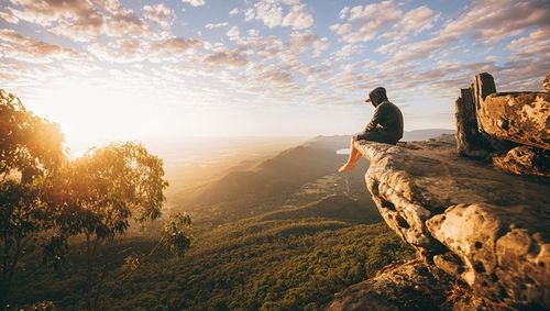 Man looking at mountain against sky