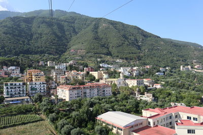 High angle view of townscape and mountains against sky