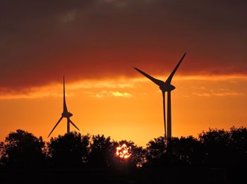 Silhouette of windmill against sky during sunset