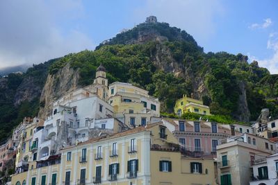 Low angle view of buildings in town against sky