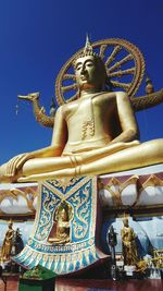 Low angle view of statue against blue sky