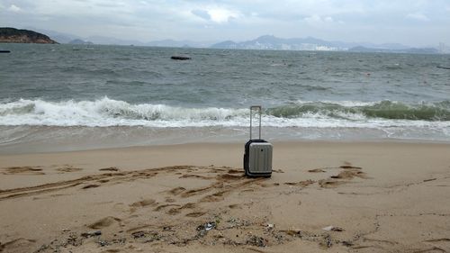 Lifeguard hut on beach against sky