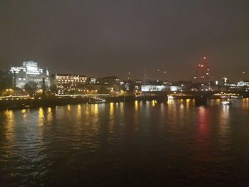 Illuminated city at waterfront