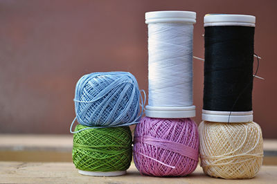 Close-up of thread spools on table