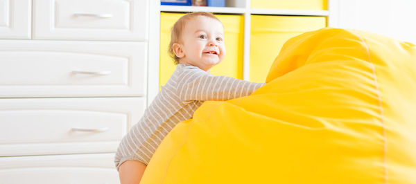 Side view of smiling boy at home