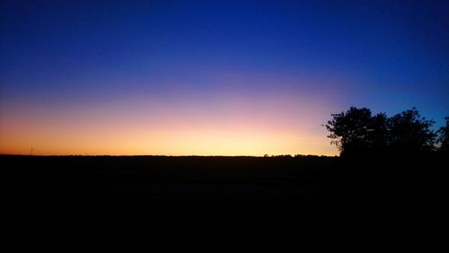 Scenic view of silhouette landscape against clear sky during sunset