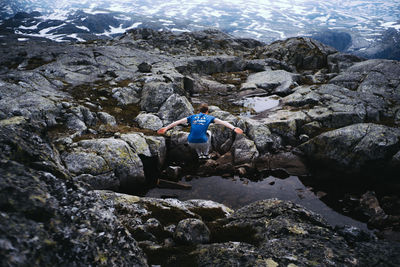 Rear view of woman on rock formation