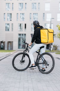 Man riding bicycle on street