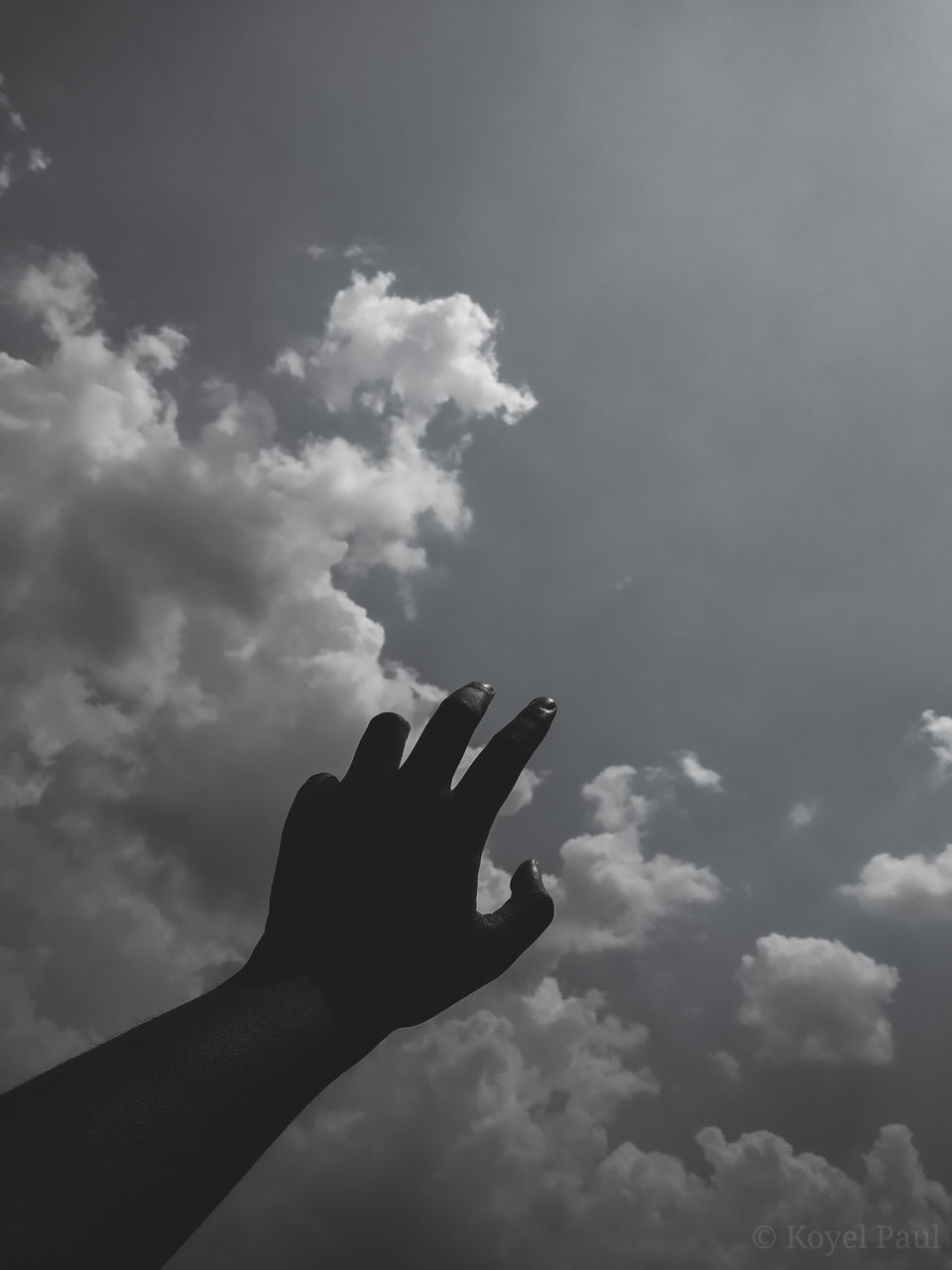 LOW ANGLE VIEW OF HUMAN HAND AGAINST SKY