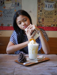 Young woman drinking glass